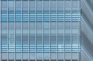 Modern futuristic glass building abstract background. Exterior of office glass building architecture. Facade of sustainable business building. Energy saving architecture. Glass window of company. photo