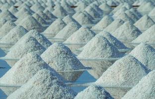 Sea salt farm in Thailand. Organic sea salt. Evaporation and crystallization of sea water. Raw material of salt industrial. Sodium Chloride. Solar evaporation system. Iodine source. Closeup salt pile photo