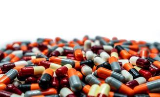 Pile of colorful antibiotic capsule pills. Pharmaceutical industry. Drug production. Pharmacy drugstore background. Global healthcare. Drug interaction. Antibiotic drug resistance concept. photo