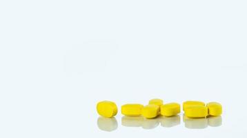 Yellow tablets pills on white background. Painkiller medicine. Prescription drug. Pharmaceutical industry. Health care and medicine concept. Pharmacy banner. Pharmacology and toxicology concept. photo