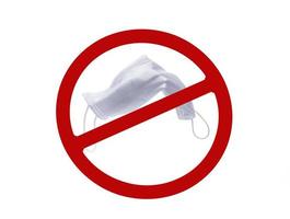 Used white surgical face mask in red forbidden symbol on white background. No discard used medical face mask in this area. Medical waste management with hygienic rule in hospital and community. photo