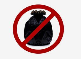 la bolsa de plástico negra contiene basura llena y ata la bolsa con un cartel rojo prohibido. no tirar basura en esta zona signo aislado sobre fondo blanco. bolsa de basura de plástico negro con el cartel de no tirar basura aquí. foto