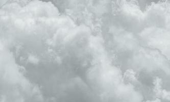 Grey and white fluffy clouds texture. Closeup detail of white clouds texture background. Soft-touch feeling like cotton. White puffy clouds. Gloomy and moody sky. Background for dead and tranquility. photo