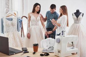 Must be awesome. The process of fitting the dress in the studio of hand crafted clothes photo