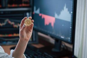 Team of stockbrokers are having a conversation in a office with multiple display screens photo
