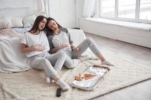 That one slice was superfluous. Twins have full stomach with pizza. Nice bedroom at daytime photo