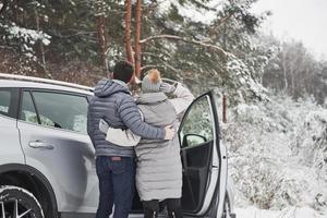 Rear view. Lovely couple have weekend at countryside at winter time photo