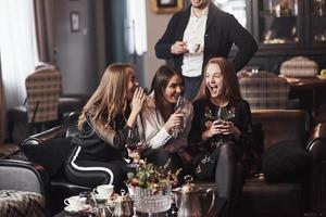 Laughing together. Family friends having nice time in beautiful luxury modern restaurant photo