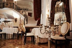 Interior of luxury restaurant in vintage aristocratic style with piano on the stage photo