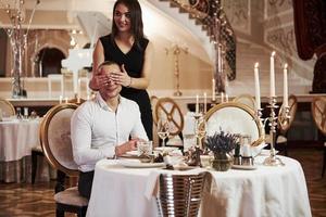 I'm here, hope you don't waited long. Beautiful couple have romantic dinner in luxury restaurant at evening time photo