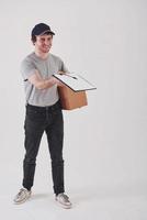 It's your document. Guy with box in hands stands against white background in the studio photo