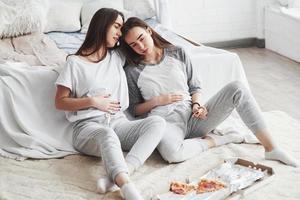 I told you that was to much. Twins have full stomach with pizza. Nice bedroom at daytime photo