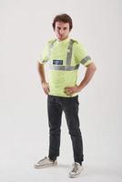 Policeman in green uniform stands against white background in the studio photo