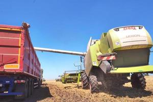 TERNOPIL - JULY 20 Combine harvester in action on wheat field. Harvesting is the process of gathering a ripe crop from the fields on July 20, 2017, in Ternopil photo