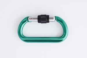 Touristic extreme sports. Isolated photo of climbing equipment - green colored part of carabiner