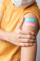 woman showing plaster after receiving covid 19 vaccine. Vaccination, herd immunity, side effect, booster dose, vaccine passport and Coronavirus pandemic photo