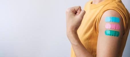 woman showing plaster after receiving covid 19 vaccine. Vaccination, herd immunity, side effect, booster dose, vaccine passport and Coronavirus pandemic photo