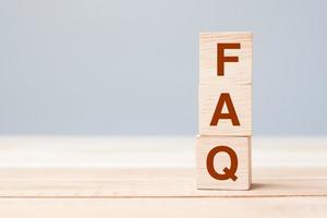 wooden cube blocks with FAQ text on table background. Financial, marketing and business concepts photo