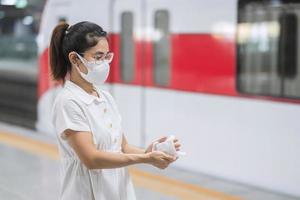 woman clean hand by wet wipe tissue in public transportation, protection Coronavirus disease infection.safety travel and  personal hygiene concepts