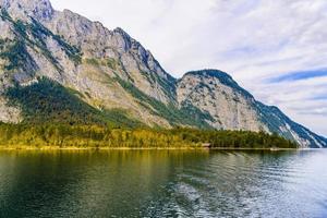 Wooden old fish house on the lake Koenigssee, Konigsee, Berchtesgaden National Park, Bavaria, Germany photo