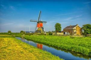 Windmills and water canal in Kinderdijk, Holland or Netherlands. photo