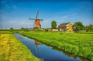 Windmills and water canal in Kinderdijk, Holland or Netherlands. photo