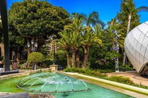 Fountain with palms in park of La Condamine, Monte-Carlo, Monaco, Cote d'Azur, French Riviera photo