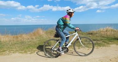 Young woman bicycle rider in sunny summer day video