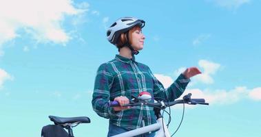 Young woman bicycle rider in sunny summer day video