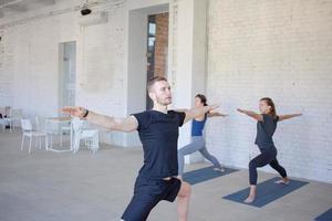 yoga class training, morning exercises in white interior photo