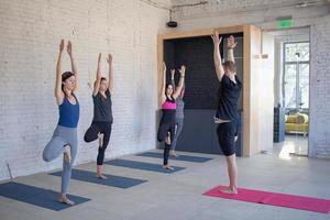 yoga class training, morning exercises in white interior photo