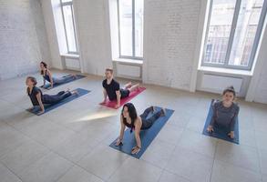 yoga class training, morning exercises in white interior photo