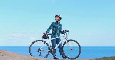 Young woman bicycle rider in sunny summer day video