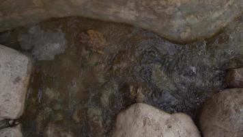 Aerial Slow Zoom on Flowing Stream Surrounded by Rock and Stone video