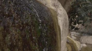 Close Up of Water Flowing Down Rock Surface by a Running Stream video