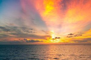 Beautiful sunset sky. Beach sunset. Twilight sea and sky. Tropical sea at dusk. Dramatic orange and blue sky. Calm sea. Sunset abstract background. Golden sky in the evening. Calm and relax life. photo