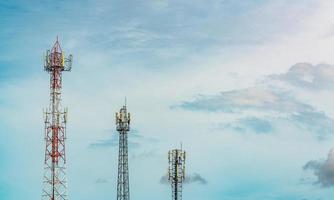 Telecommunication tower with blue sky and white clouds. Antenna on blue sky. Radio and satellite pole. Communication technology. Telecommunication industry. Mobile or telecom 4g network. Technology photo