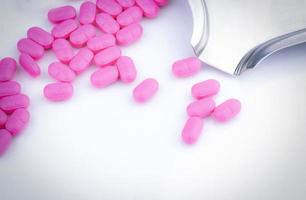 Top view of pink tablets pills on stainless steel drug tray. Pharmaceutical industry. Pharmacy drugstore products. Drug count. Medication use in hospital. Pharmacology. Prescription drugs. Healthcare. photo