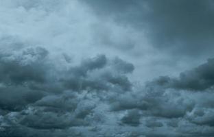 Dark dramatic sky and clouds. Background for death and sad concept. Gray sky and fluffy white clouds. Thunder and storm sky. Sad and moody sky. Nature background. Dead abstract background. Cloudscape. photo