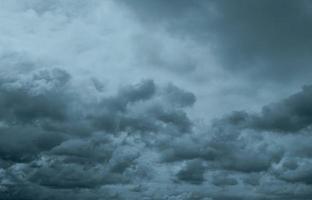 Dark dramatic sky and clouds. Background for death and sad concept. Gray sky and fluffy white clouds. Thunder and storm sky. Sad and moody sky. Nature background. Dead abstract background. Cloudscape. photo