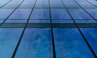 Perspective view of modern futuristic  glass building abstract background. Exterior of office glass building architecture. Reflection in transparent glass of business building. Company glass window.