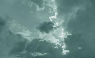 Dark dramatic sky and clouds. Background for death and sad concept. Gray sky and fluffy white clouds. Thunder and storm sky. Sad and moody sky. Nature background. Dead abstract background. Cloudscape. photo