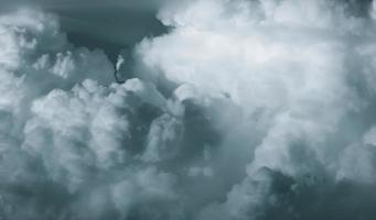 White fluffy clouds on dark sky. Soft touch feeling like cotton. Stormy sky before raining. Beauty in nature. The combination of rain clouds before rain. Close-up group of clouds texture background. photo