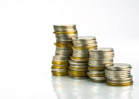 Macro shot detail of golden and silver color coin stacks on white background with copy space for text. Business and finance growth, saving money, investment and interest concept. photo