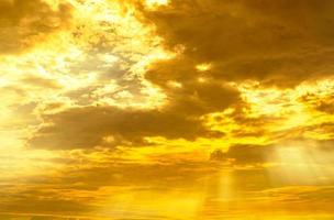 God light. Dramatic golden cloudy sky with sun beam. Yellow sun rays through golden clouds. God light from heaven for hope and faithful concept. Believe in god. Beautiful sunlight sky background. photo