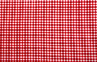 Red and white checkered tablecloth. Top view table cloth texture background. Red gingham pattern fabric. Picnic blanket texture. Red table cloth for Italian food menu. Square pattern of gingham. photo