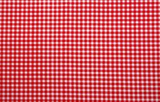 Red and white checkered tablecloth. Top view table cloth texture background. Red gingham pattern fabric. Picnic blanket texture. Red table cloth for Italian food menu. Square pattern of gingham. photo