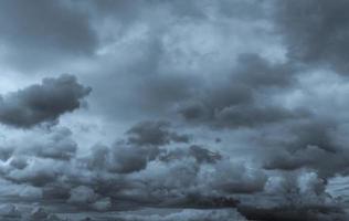 Dark dramatic sky and clouds. Background for death and sad concept. Gray sky and fluffy white clouds. Thunder and storm sky. Sad and moody sky. Nature background. Dead abstract background. Cloudscape. photo