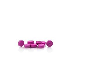 Pile of round pink small tablets pills isolated on white background with copy space for text. Bronchodilator medicine for treatment asthma in adult. Salbutamol Albuterol tablets pills. photo