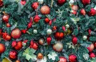 Close up Christmas tree decoration with red ball, gold ball, golden snowflake, red star. Xmas background. Christmas and Happy New Year holiday background. photo